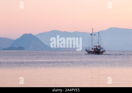 Reise Boot aus dem Hafen und Segeln in die Ferne in der Morgendämmerung, Kos, Griechenland Stockfoto