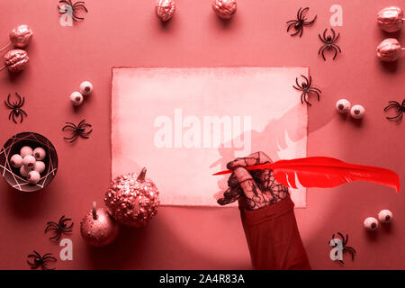 Kreative Halloween Hintergrund in Coral Farbe, Rot und Schwarz. Hexe schreiben auf Pergament mit Federkiel. Wohnung mit Spinnen, dekorative Metallic Pink Pu Stockfoto