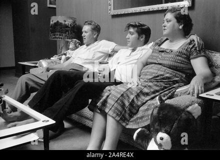 Elvis Presley mit seinem Vater, Vernon, und seine Mutter Gladys Presley, im Wohnzimmer 1034 Audubon Drive, Memphis, Tennessee, 29. Mai 1956 Stockfoto