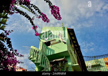 Grüner Stein Wendeltreppe und lila Bougainvillea gegen tropischen Himmel in perspektivischer Ansicht im historischen Joo Chiat, Singapur Stockfoto