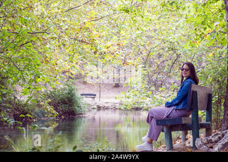 Nettes solo, Lonely Girl, Frau, Frauen, Ausruhen, Entspannen, während im Naturpark durch die Vegetation im Herbst, oder im Herbst in Murcia, Spanien, 20 umgeben sitzt Stockfoto