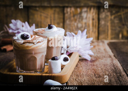 Happy Monster, Pumpkin spice Latte mit Schlagsahne und großen Marshmallow Auge auf der Oberseite, Halloween Dessert im Glas Stockfoto