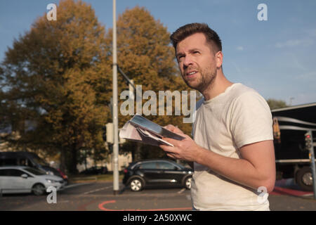 Kaukasischen jungen Mann Tourist auf der Straße mit einem Guide in der neuen Stadt verloren Stockfoto