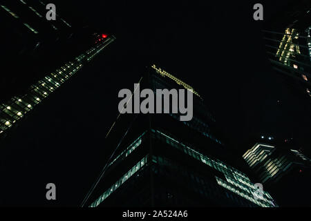 Ansicht von unten auf das Business Gebäuden und Wolkenkratzern in London bei Nacht Stockfoto