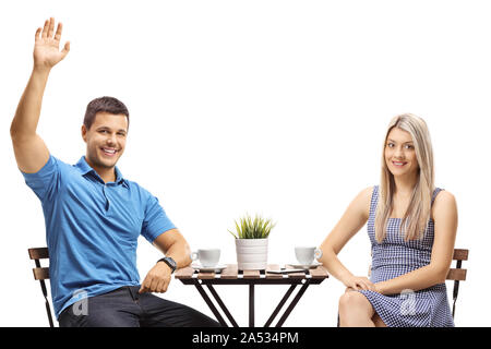 Junges Paar in einem Café auf weißem Hintergrund sitzen Stockfoto