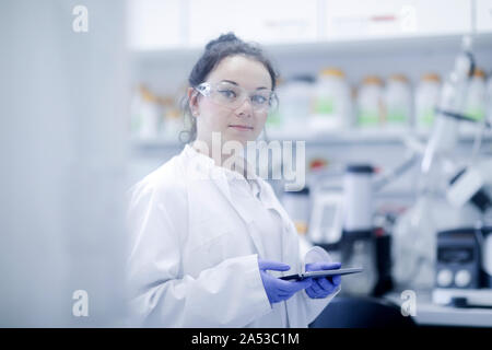 Junge Wissenschaftlerin Frau mit Tablet-PC in einem Labor Stockfoto