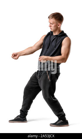 Seitenansicht des stattlichen muskulösen jungen Mann ziehen etwas isoliert auf weißem Hintergrund Stockfoto