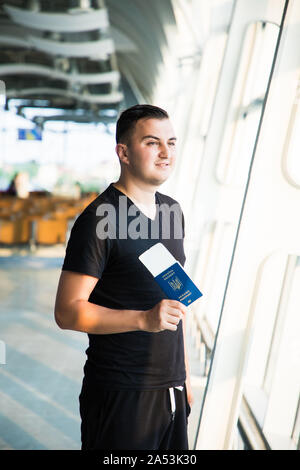 Junge Menschen auf dem Weg in Flughafen zum Tor, während die im Besitz eines ukrainischen Pass und Ticket Stockfoto