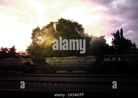 Ein bunter Sonnenaufgang über einem kleinen Bahnhof in Thailand Stockfoto