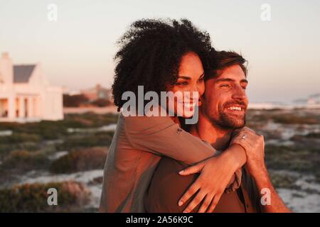 Paar beim Sonnenuntergang am Strand. Stockfoto