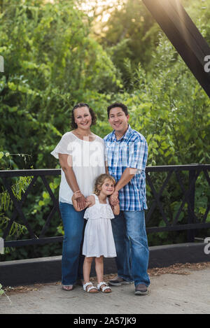 Lächelnd Eltern umarmt entzückende Tochter auf Steele Canyon Bridge Stockfoto