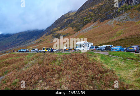 Einer der Parkplätze und Aussichtspunkte entlang der A82 Straße in Glencoe, mit Besuchern Fahrzeuge gegenüber den Drei Schwestern Berge geparkt. Stockfoto