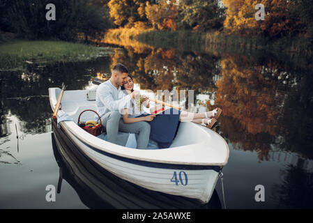 Liebe Paar mit Obstkorb in einem Boot liegend Stockfoto