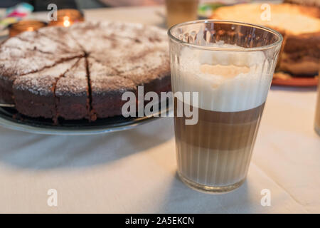 Café au lait und Schokolade Kuchen auf dem Tisch Stockfoto