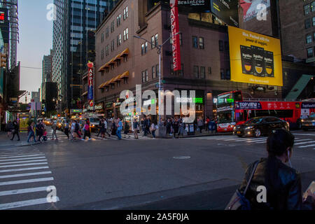 Oktober 14, 2019 - Times Square, New York, USA - Kreuzung von West 50th und 7th Avenue in Downtown Manhattan mit Gregory's Kaffee und Applebees Stockfoto