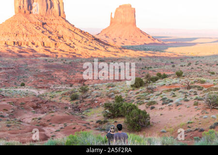 Monument Valley, USA - 12. August 2019: Leute Paar Handschuhe an berühmten Butte mesa Formationen Canyons bei Sonnenuntergang in Arizona Stockfoto