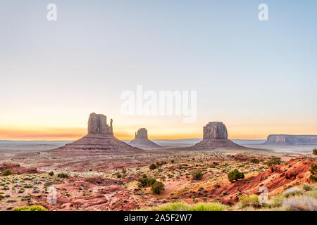 Weitwinkelaufnahme der Buttes und Horizon im Monument Valley bei Sonnenaufgang buntes Licht in Arizona mit orangefarbenen Felsen Stockfoto