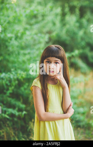 Mädchen Spaziergänge in den Wäldern. Mädchen gehen in den Park. ein kleines Mädchen von 9 Jahren ging für einen Spaziergang auf der Straße im Sommer oder Anfang Herbst. Schulmädchen zu Fuß Stockfoto