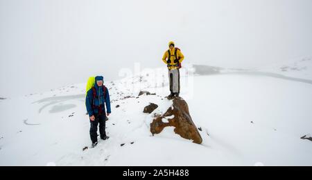 Wanderer am Emerald Lake Suche im Schnee, gefroren Emerald Lakes, Tongariro Alpine Crossing, Tongariro National Park, South Island, Neuseeland Stockfoto