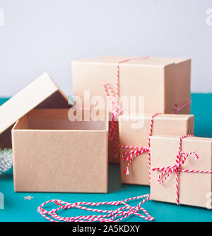 Verschiedene Größen Weihnachten Geschenkboxen auf dem blauen Hintergrund. Ein Kasten ist offen und leer. Stockfoto