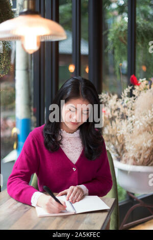 Frau schreiben im Editor im café Stockfoto