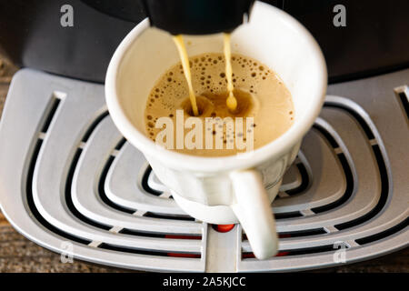 Kaffeemaschine, frischen Kaffee mit sichtbarer Dampf über Cup. Stockfoto