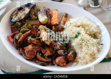 Abendessen in Zypern einschließlich einiger würzigen Fleisch, gekochtem Reis und gegrilltem Gemüse wie Karotten und Zucchini. Gesunde und köstliche mediterrane Gerichte. Stockfoto