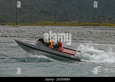 TARAMAKAU FLUSS, WEST COAST, NEUSEELAND, September 3, 2019: Drei Leute an die Macht ihrer Jetboot, das Taramakau Fluss Stockfoto