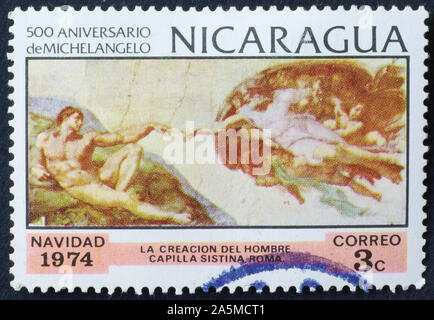 Die Erschaffung des Menschen durch Michelangelo auf Briefmarke von Nicaragua Stockfoto