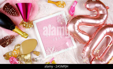 Silvester flatlay hygge Stil Overhead mit Rose Gold 20 Luftballons und Schreiben board Rechtschreibung Frohes neues Jahr wünscht. Stockfoto