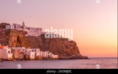 Nisyros, Greeec. Sonnenuntergang in Mandraki Village, die Hauptstadt der Insel Nisyros, Griechenland. Im Hintergrund ist das Kloster Panagia Spiliani. Stockfoto