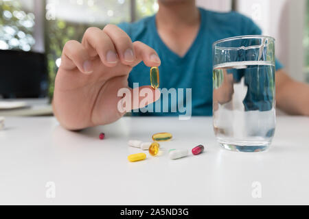 Junger Mann mit der pharmazeutischen Medizin Pillen in der Hand Stockfoto