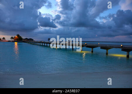 Fußgängerbrücke von Paradise Island (lankanfinolhu) bei Dämmerung, Malediven Stockfoto