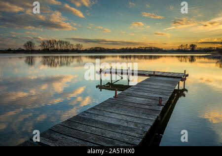 Pier am See, Reflexion von Wolken im Wasser nach Sonnenuntergang, im östlichen Polen Stockfoto