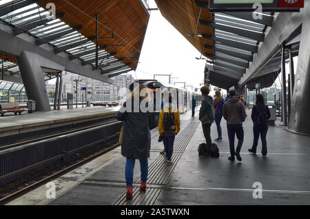 Amsterdam, Holland, August 2019. Im U-Bahnhof Bijlmer Arena, Reisende warten, bis der Zug am Kai. Eine moderne Struktur aus Stahl und Woo Stockfoto