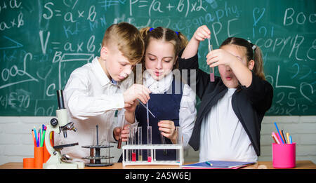 Chemische Reaktion auftritt, wenn Inhalt in neue Substanzen. Schüler Studie Chemie in der Schule. Kinder genießen chemischen Experiment. Chemische Substanz löst sich in ein anderes. Die Erkundung ist so spannend. Stockfoto