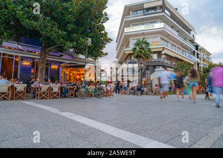 Trikala Griechenland - 24 Juli 2019; Lange Belichtung Urban Street Scene im Abendlicht mit unscharfen Menschen zu Fuß in die Fußgängerzone. Stockfoto