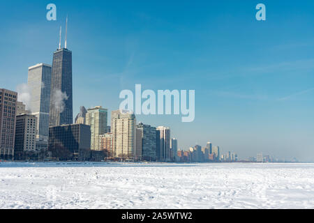 Chicago Skyline vom Ohio Street Beach aus mit dem Lake Michigan, der nach einem Polar Vortex in Schnee und Eis bedeckt ist Stockfoto