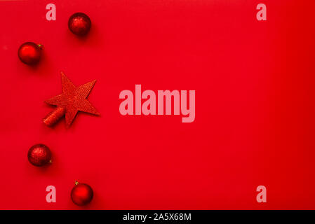 Weihnachten Hintergrund - Flach von Red christmas Star und Bälle über den roten Hintergrund. Kopieren Sie Platz. Stockfoto