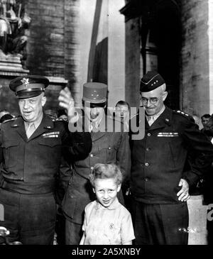 Vor dem berühmten Arc De Triomphe in Paris, General Dwight D. Eisenhower, Links, Supreme Allied Expeditionary Force Commander, Adressen zujubeln, Franzosen. Zu seiner Linken, Gen. Joseph Koenig, militärischer Befehlshaber General von Paris, und Generalleutnant Omar N. Bradley, Kommandeur der 12. Armee Gruppe auf dem Kontinent, in der Mitte ein glückliches französischen Kind, Frankreich, 27. August 1944. Stockfoto