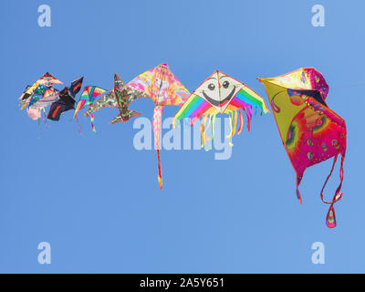 Helle, farbenfrohe Drachen fliegen im Hintergrund auf den blauen Himmel. Ein Kite ist eine Sammlung von halteband-gekoppelte Flügel setzt. Kindheit Spiel. Freizeitaktivität. Stockfoto