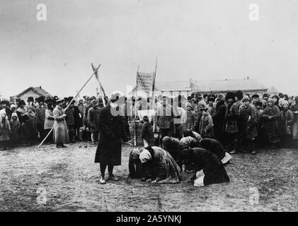Hungrige russische Frauen Knien vor der American Relief Administration Beamten während der großen Hungersnot in Russland 1922. Stockfoto