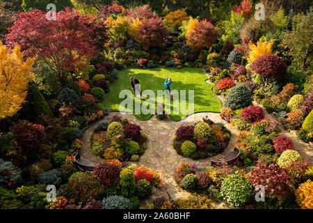 Rentnerehepaar Tony und Marie Newton neigen dazu, ihre Vier Jahreszeiten Garten als es in herbstlichen Farben platzt an ihrem Haus in Walsall, West Midlands. Stockfoto