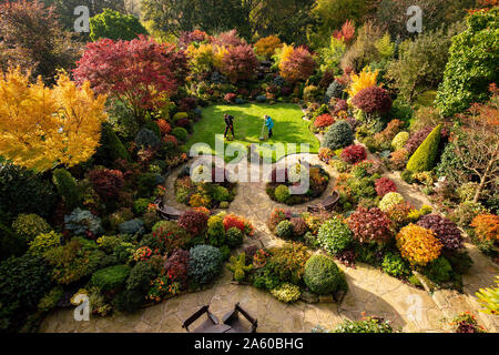 Rentnerehepaar Tony und Marie Newton neigen dazu, ihre Vier Jahreszeiten Garten als es in herbstlichen Farben platzt an ihrem Haus in Walsall, West Midlands. Stockfoto