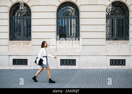 Gut gekleidete Frau, die Ordner, zu Fuß in die Stadt Stockfoto