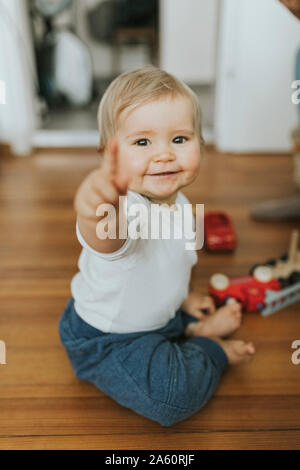 Lächelnden Mädchen Zeigefinger zu Hause Stockfoto