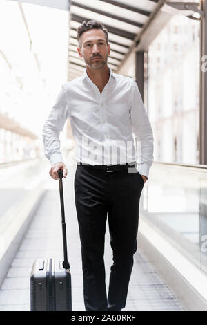 Geschäftsmann auf fahrsteig am Flughafen Stockfoto