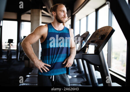 Fitness, Sport, Training und Lebensstil anhand von quantitativen Simulatio jungen Mann heraus in der Turnhalle arbeiten Stockfoto