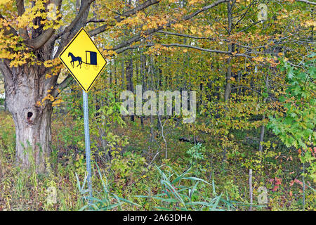 Eine gelbe und schwarze Schild Warnung Treiber von der Anwesenheit von Pferd und Wagen Transport in den Bereich des Ohio Amish Gemeinschaft besiedelt. Stockfoto