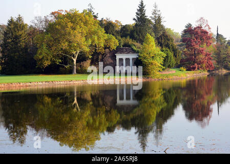 22 Oktober 2020, Sachsen-Anhalt Wörlitz: Autumnally farbige Bäume und das Nymphäum in der See im Wörlitzer Park wider. Die Dessau-Wörlitzer Gartenreich wurde von Fürst Leopold III. Friedrich Franz von Anhalt-Dessau (1740-1817) von 1764 als ersten Landschaftspark im englischen Stil auf dem europäischen Festland angelegt. Im November 2000 die umfangreiche Dessau-Wörlitzer Gartenreich, dessen Kern ist der Wörlitzer Park, wurde von der Unesco als Weltkulturerbe anerkannt. Foto: Waltraud Grubitzsch/dpa-Zentralbild/dpa Stockfoto